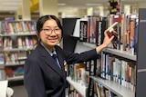 A young woman in a library.