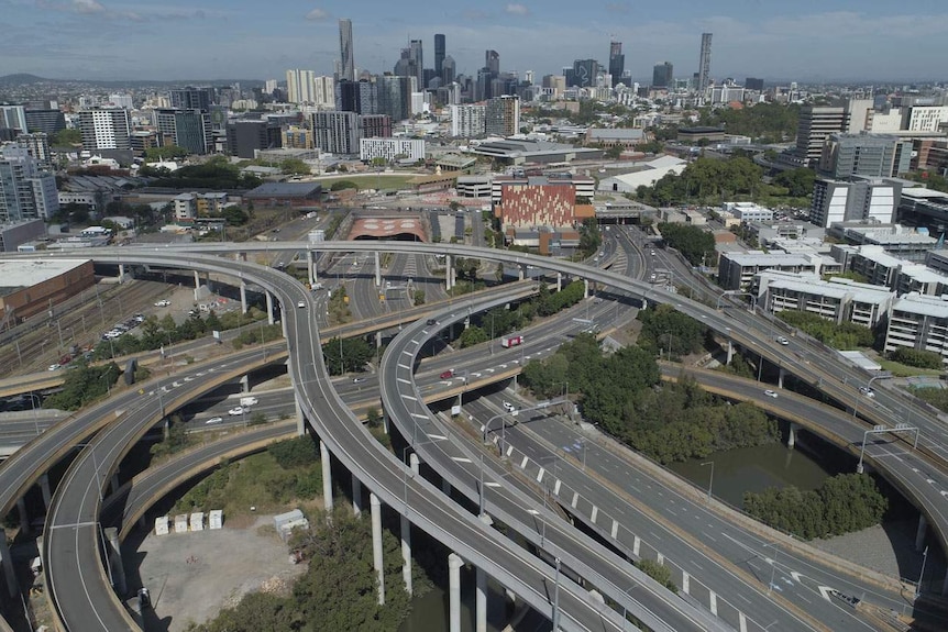 Aerial drone photo of the nearly empty city center bypass at Bowen Hills and Brisbane city skyline.
