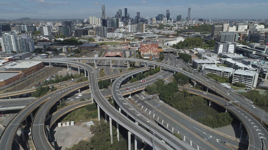 Drone aerial photo of near-empty inner-city bypass at Bowen Hills and Brisbane city skyline.