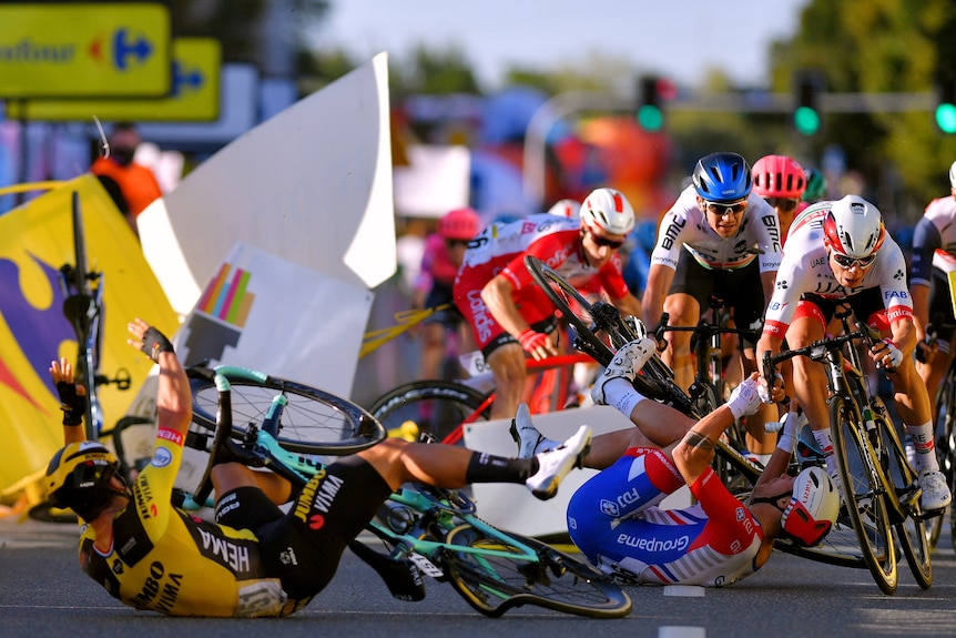 Road cycle racers crash during a race