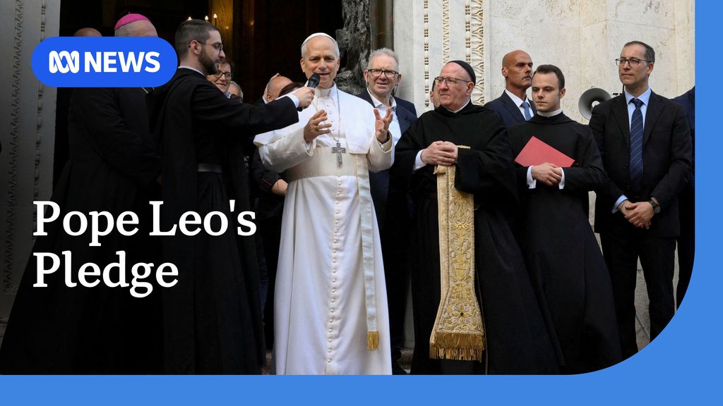 Pope Leo's Pledge: Pope Leo, wearing a white papal robe, is surrounded by men in suits and religious robes