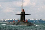 A French nuclear-powered submarine sails through choppy water.