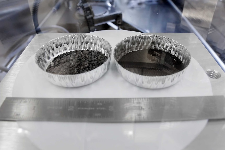 Two separate 2 inch foil pans hold lunar dirt inside a sealed chamber.