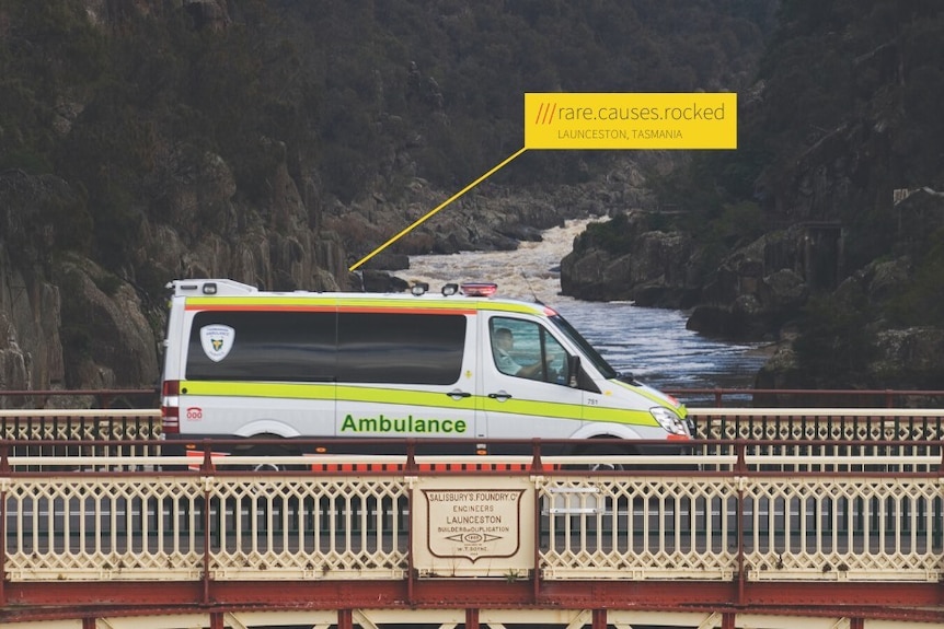 An ambulance driving across a bridge