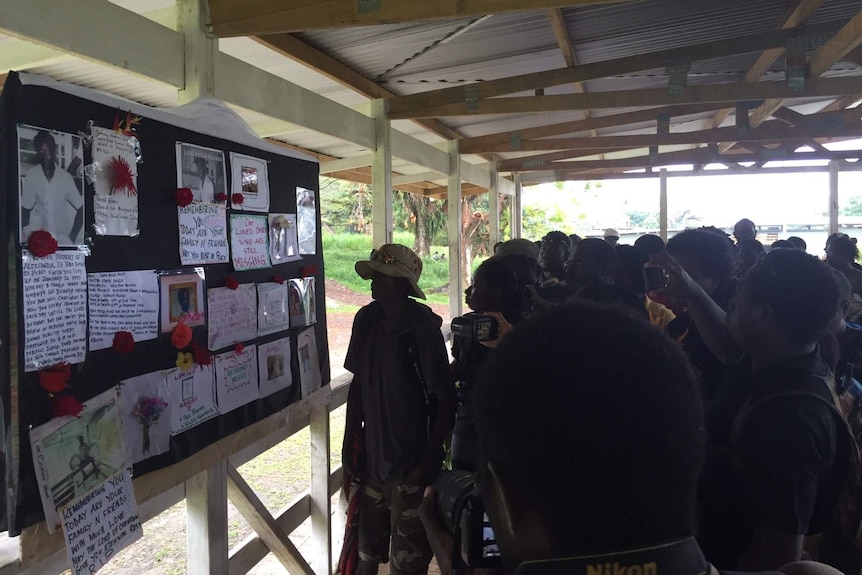 Bougainville residents looking at public posters of missing people