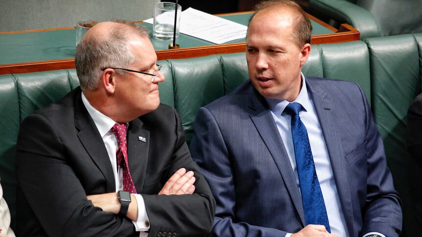 Scott Morrison and Peter Dutton sit together during Question Time