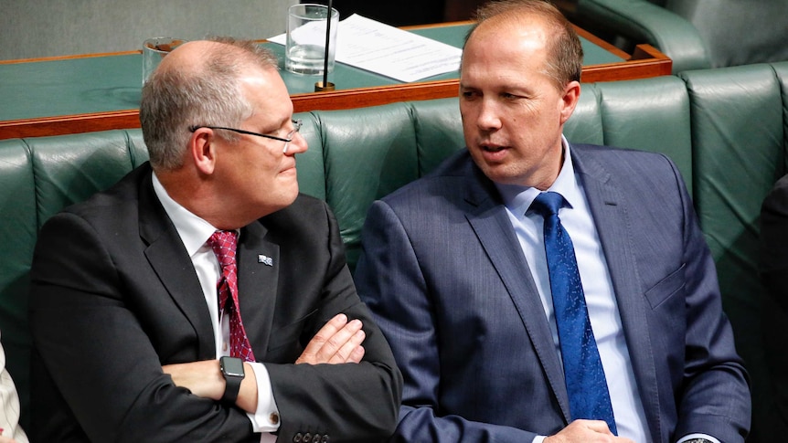 Scott Morrison and Peter Dutton sit together during Question Time