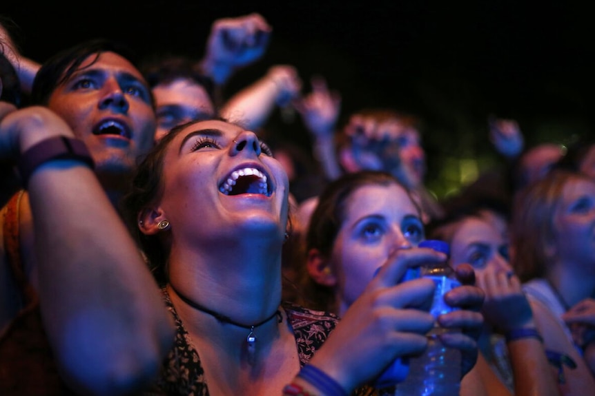 Young people laughing and having a good time at the Byron Bay Falls Festival.