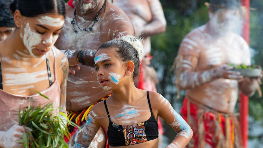 Indigenous girls dancing during a smoking ceremony