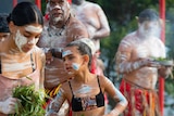 Indigenous girls dancing during a smoking ceremony
