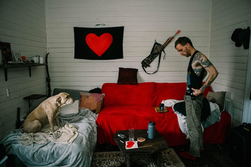 Eli Roth in the one livable room in his house with his dog Gaia.