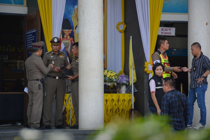 Police officers outside a Thai court.