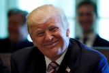 The US President smiles towards a camera
