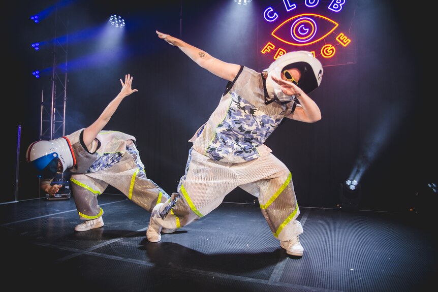 Dazza and Keif perform in space suits on stage.