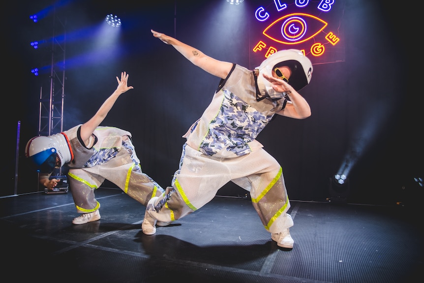 Dazza and Keif perform in space suits on stage.