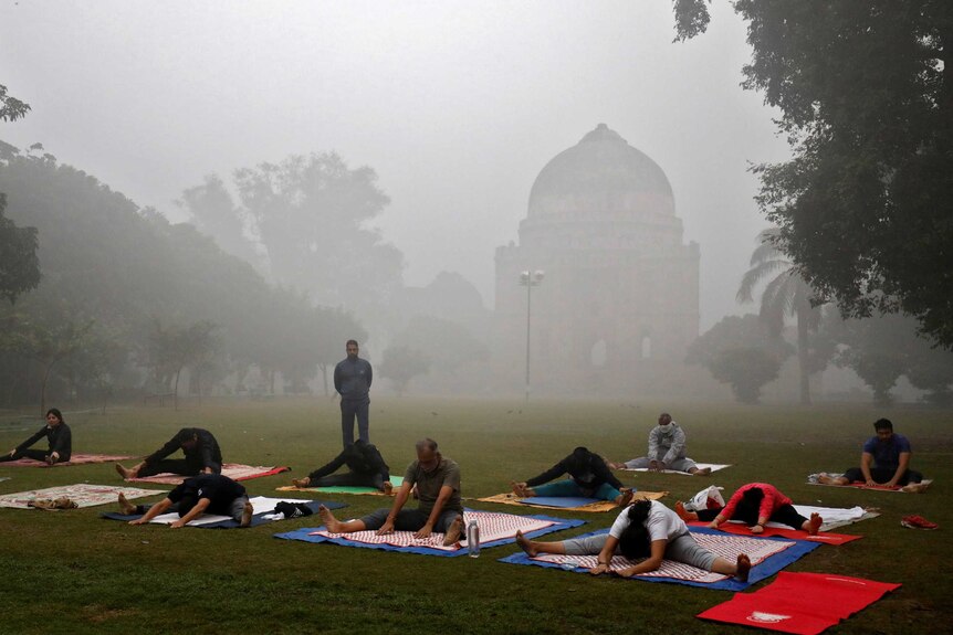 People exercise in a park on a smoggy morning in New Delhi.