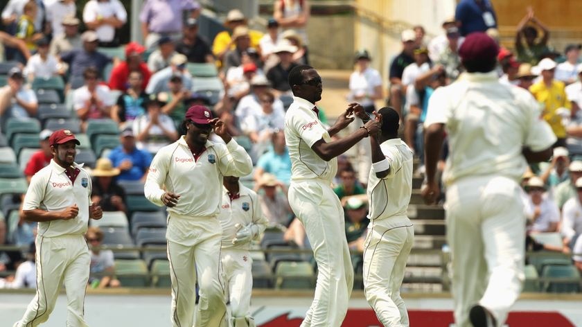 Kemar Roach picks up the prized wicket of Shane Watson.