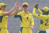 Grace Harris, Ash Gardner and Alana King high five each other during an ODI against Bangladesh.