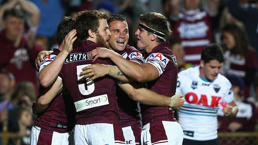 The Wolfman cometh ... David Williams celebrates one of his two tries with his Manly team-mates.