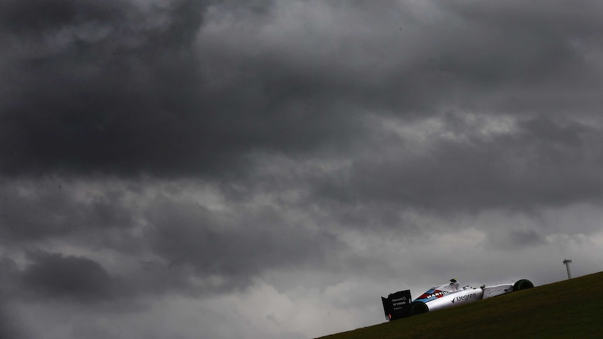 Valtteri Bottas rides with storm clouds in background