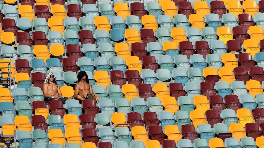 Fans sitting in an empty stand at the cricket in Brisbane.