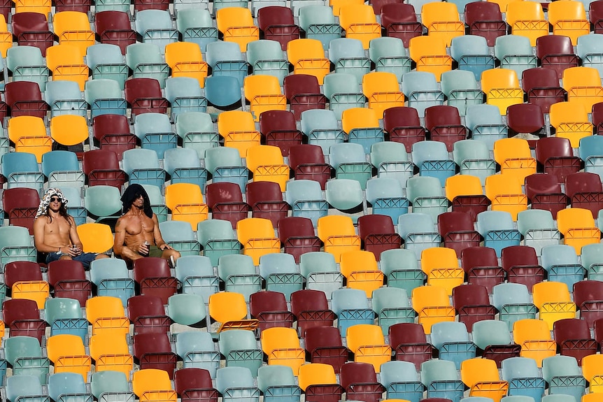 Fans sitting in an empty stand at the cricket in Brisbane.