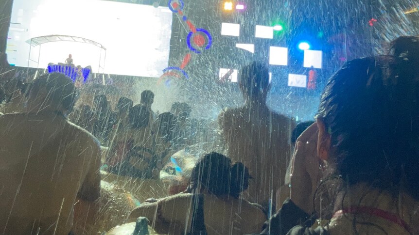 Attendees are sprayed with water at a pool party music festival in Wuhan.