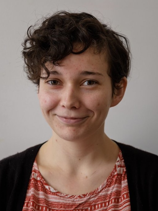 Close-up profile pic of a woman smiling.