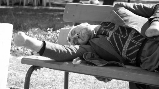 A homeless war veteran rests on a park bench. (Getty Images: Thinkstock)