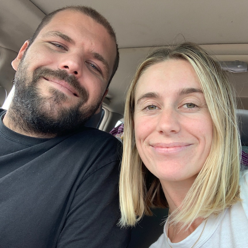 Tom Van Beem and Emma Pegrum sitting in the front seat of a car