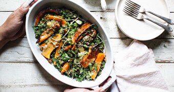 Roast pumpkin and lentil salad in a serving dish with a side of honey miso dressing, an easy recipe