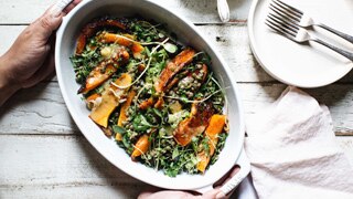 Roast pumpkin and lentil salad in a serving dish with a side of honey miso dressing, an easy recipe