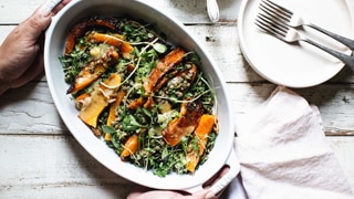 Roast pumpkin and lentil salad in a serving dish with a side of honey miso dressing, an easy recipe
