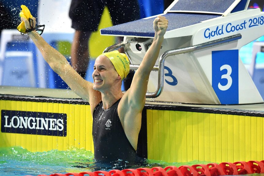 Swimmer Bronte Campbell flicks water as she celebrates 100m freestyle win