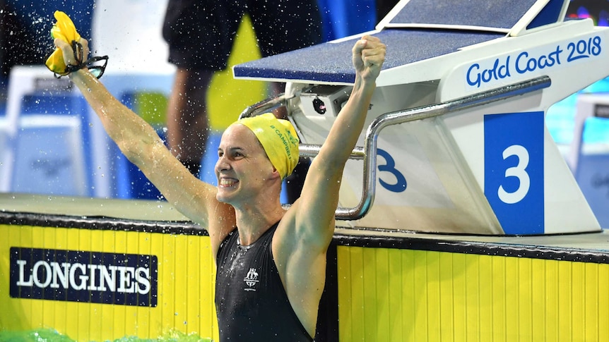 Swimmer Bronte Campbell flicks water as she celebrates 100m freestyle win