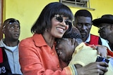 Jamaican prime minister Portia Simpson Miller hugs a supporter