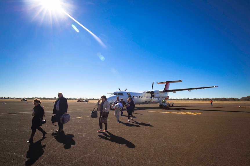 A Qantas plane sits on the tarmac.