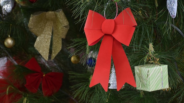 Large red bow on Christmas tree.