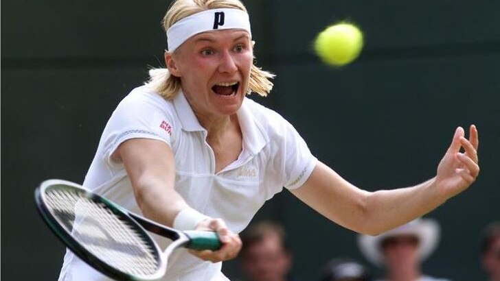 Jana Novotna runs in to hit a tennis ball coming towards her during the Wimbledon Tennis Championships in 1999.