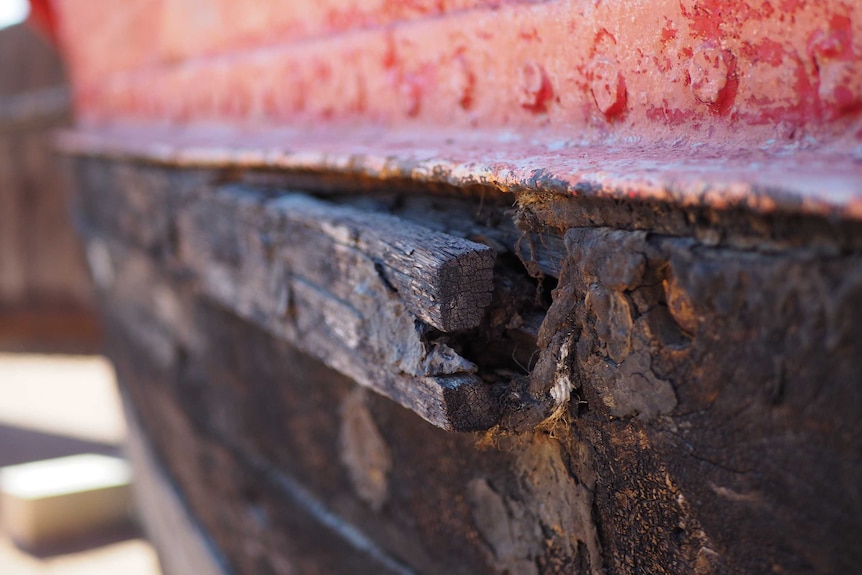 A loose wooden beam on an old barge.