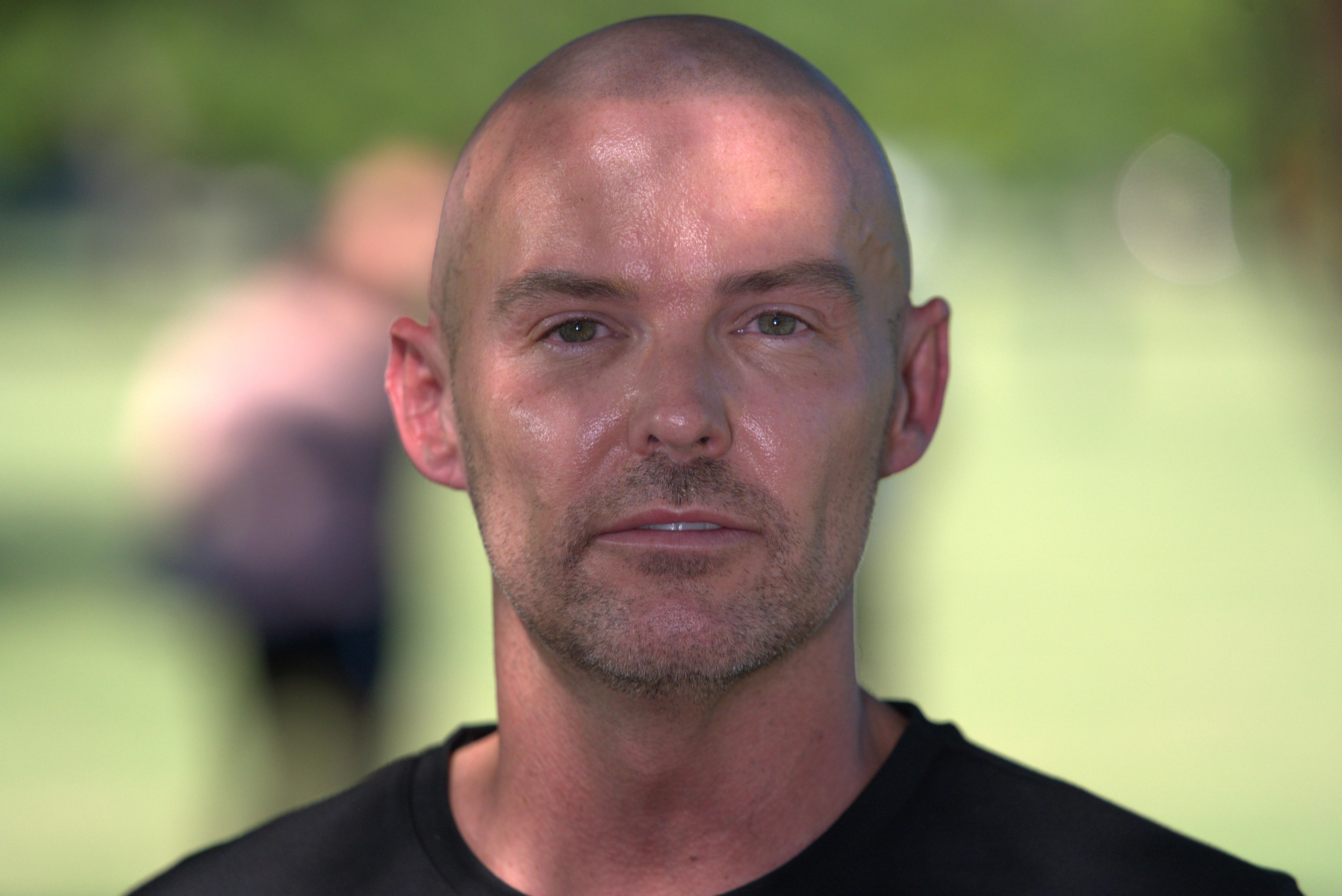 A man with a shaved head.