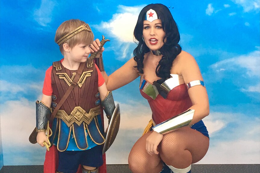 Four-year-old Jaxon in costume with Wonder Woman at Movie World, Gold Coast