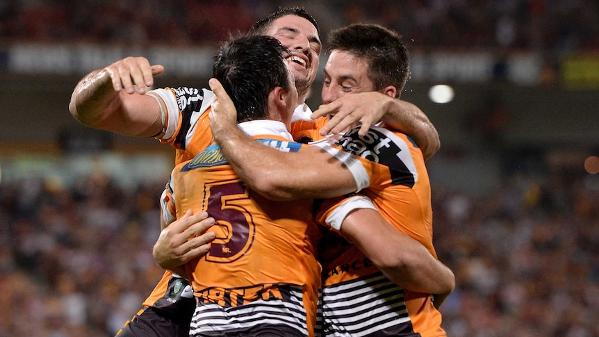 Broncos celebrate a try against Cowboys
