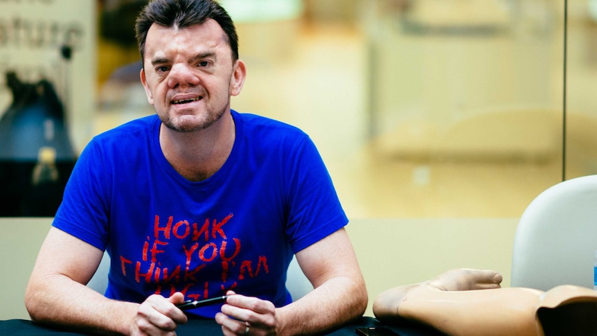 Robert Hoge sits at a book signing table at the Brisbane Writers Festival.