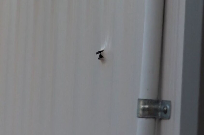 A close up of a bullet hole lodged in a demountable