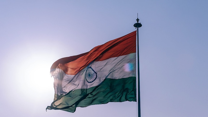 The Indian flag on a flagpole in front of the Sun