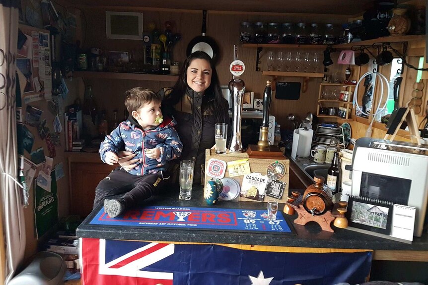 Interior of The Outpost bar, Shetland, with Australian expat Elissa Moar-Dow and son behind the counter.