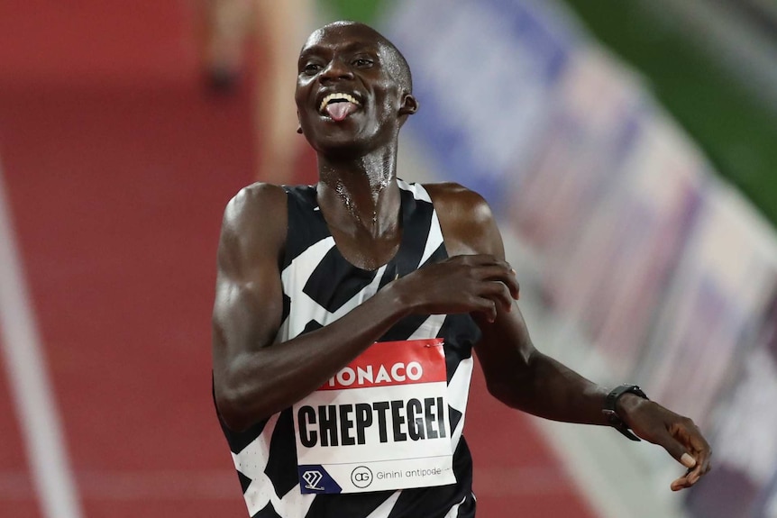 Uganda's Joshua Cheptegei stick his tongue out as he crosses the finishes line in the men's 5,000 metres final