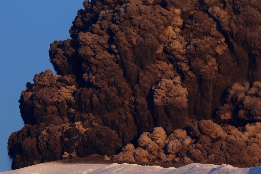 Ashes, smoke, and rocks are thrown skyward as a volcano continues to erupt