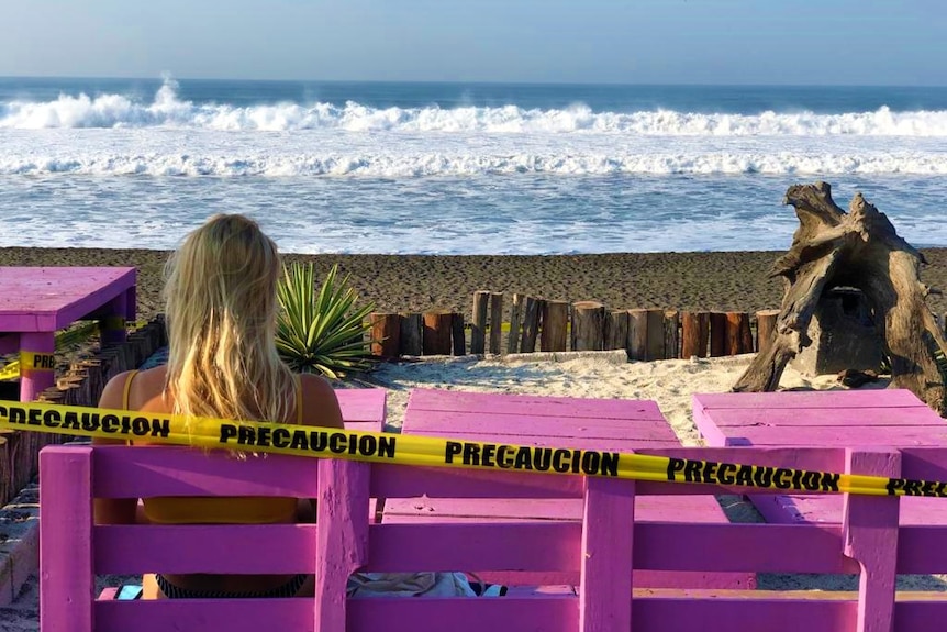 A surfer eyes the break at Playa el Paredon, Guatemala, shortly before the nationwide lockdown was announced in March 2020.